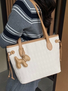 Elegant white quilted tote bag with brown trim and cute puppy charm for women