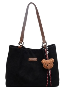 Large black faux suede tote bag with brown leather straps and a plush bear pendant