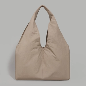 Macro shot of large capacity beige tote bag showing high-quality nylon fabric texture