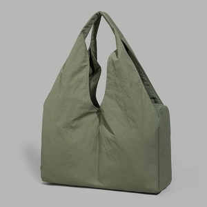Close-up of army green wrinkled nylon tote bag showing textured fabric and stitching details