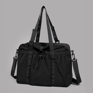 Detail of black tactical nylon travel bag with MOLLE system and adjustable straps
