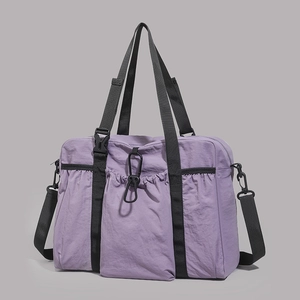 Macro detail of purple water-repellent nylon fabric texture and drawstring pocket on tote bag