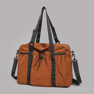 Macro detail of caramel brown crinkle nylon travel tote with elastic drawstring pocket
