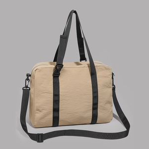 Detailed close-up of khaki travel tote showing reinforced straps and durable nylon texture