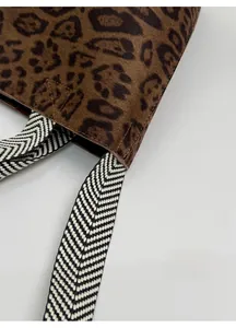 Detail of leopard print tote bag with reinforced Chevron pattern shoulder strap stitching