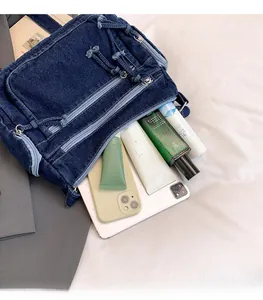 Internal view of denim crossbody bag showing spacious storage for daily essentials
