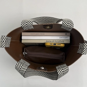 Top view of suede bucket bag interior showing magnetic closure and large capacity