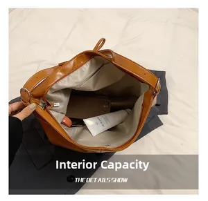 Internal capacity of the brown suede tote bag showing phone and skincare items