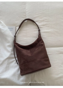 Close-up of deep brown suede Hobo bag with adjustable shoulder strap and matte texture
