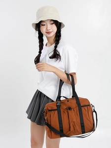 Brown large capacity travel tote bag with nylon finish and adjustable shoulder strap