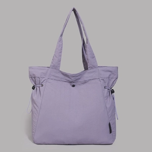 Detail shot of lavender tote bag featuring adjustable black side drawstrings and nylon texture