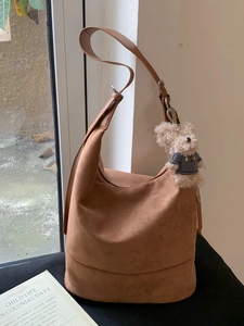 Brown matte hobo shoulder bag with adjustable strap and cute teddy bear pendant