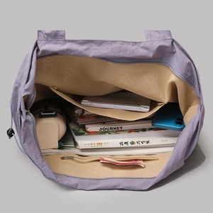 Top view of the purple nylon tote bag showing spacious interior compartments and lining