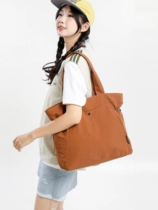 Large capacity caramel tote bag with side drawstring and wide shoulder straps