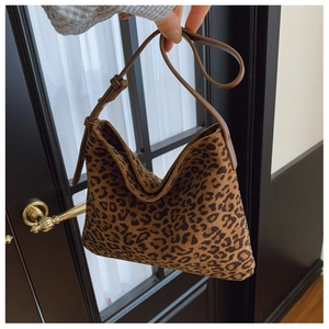 Dettaglio della tracolla in pelle regolabile e borsa hobo leopardata con trama scamosciata
