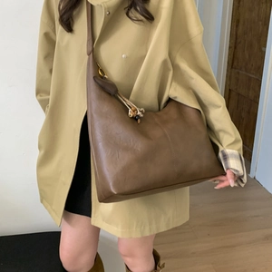Brown leather large tote bag with decorative bead charms and wide shoulder strap style