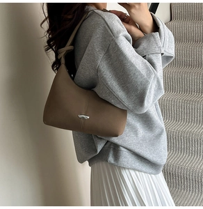 Chic brown hobo shoulder bag with silver metal oval hardware and knot strap detail