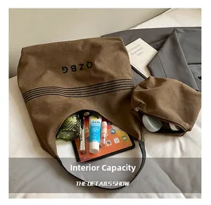 Detail view of large canvas tote bag interior showing capacity for tablet and cosmetics