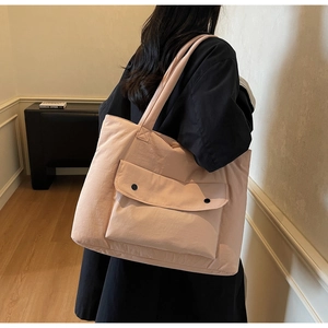 Detailed back view of a peach pink tote bag showing large capacity and front pockets