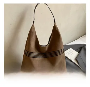 Detail of vintage brown canvas Hobo bag showing OZBG logo and black striped pattern