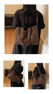 Detail of a large dark brown retro tote bag with matte texture and metallic buckles