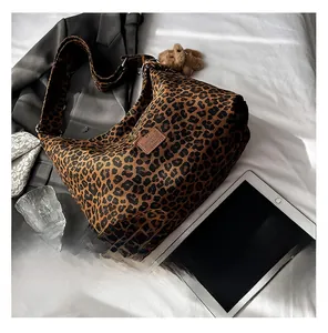 Detail of leopard print tote bag with leather label and soft canvas texture