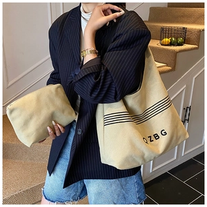 Detail of khaki canvas tote and matching pouch set with black stripes and QZBG logo
