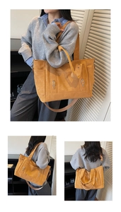 Detail view of mustard yellow multi-pocket canvas tote with metal ring hardware
