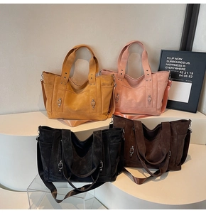 Detail of four colorful leather tote bags with metallic studs and silver hardware