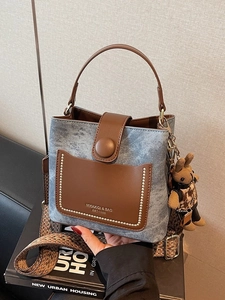 Blue denim and brown leather bucket bag with retro woven strap and bear charm
