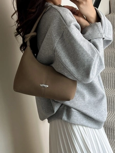 Fashionable light brown crescent shoulder bag for women with silver buckle and leather strap