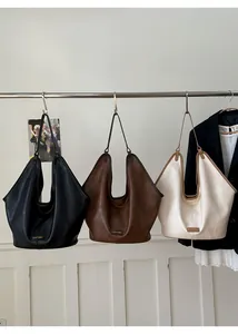 Detailed view of large capacity tote bags in black, dark brown, and cream white colors