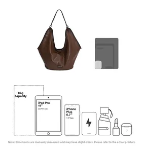 Detail view of large brown hobo bag showing capacity for 11 inch iPad and daily essentials