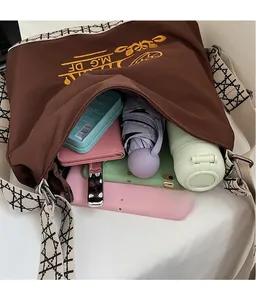 Interior view of brown canvas bucket bag showing large capacity for umbrella and bottle