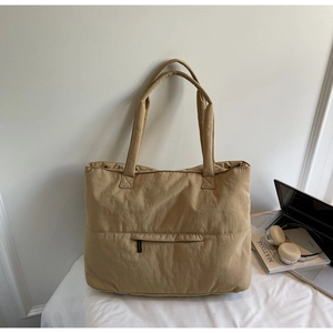Detail of khaki large capacity nylon tote bag with front zipper pocket for commuting