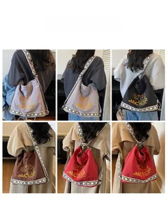 Detailed views of embroidered canvas bucket bags in four colors with geometric straps