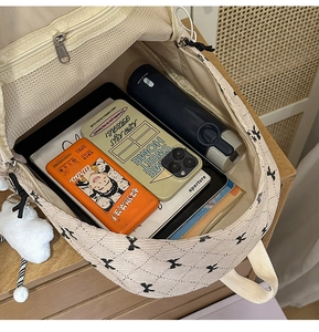 Detail of quilted corduroy backpack interior showing spacious storage and mesh pocket
