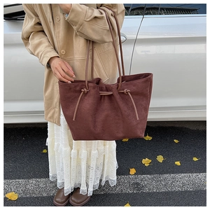 Deep brown oversized suede tote bag styled with a minimalist autumn trench coat look