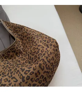 Detailed close-up showing the leopard print canvas texture and durable fabric material