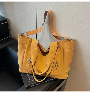 Detail of ginger yellow canvas tote bag with adjustable strap and smooth suede texture