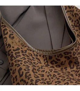 Macro shot of precise stitching and premium leopard print fabric on a versatile tote bag