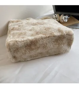 Detail view showing soft brown spotted plush texture and wide base of the shoulder bag