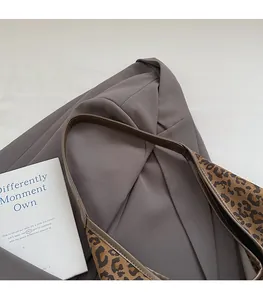 Detail of leopard print shoulder bag with comfortable brown leather strap and stitching