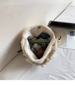 Interior view of plush cream bucket bag showing spacious storage for phone and makeup