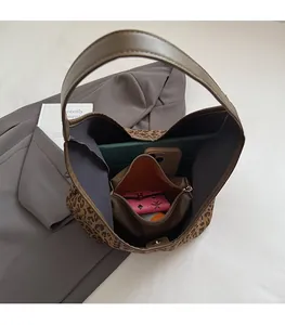 Top view of large leopard print tote bag interior showing ample storage for iPad and wallet