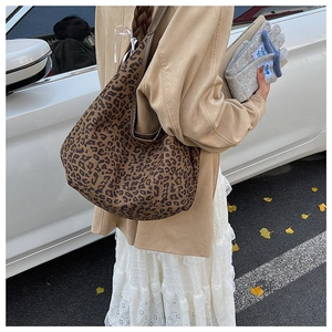 Street style view of large leopard print hobo tote bag worn as casual shoulder bag