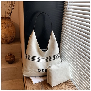 Detail of canvas tote bag set with striped print and matching small zipper pouch