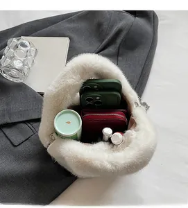 Spacious interior of white faux fur chain bag showing phones and wallet storage