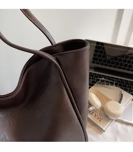 Close-up of vintage brown soft leather tote bag material with matte texture for women
