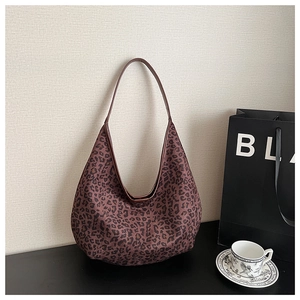 Detailed close-up of a vintage leopard print tote bag with soft suede texture and large capacity
